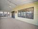 Carpeted screened porch with ceiling fan at 134 Lake Hazel Dr, Winter Haven, FL 33884