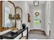 Bright and airy entryway with console table, mirrors, and a stylish rug at 1419 S Lincoln Ave, Lakeland, FL 33803