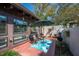 Inviting patio with seating area, umbrella, and lush landscaping at 17 Loma Verde # 17, Lakeland, FL 33813
