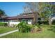 Landscaped yard with walkway to charming house entrance at 17 Loma Verde # 17, Lakeland, FL 33813