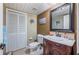 Half bathroom with dark wood vanity, white toilet and stylish mirror at 17 Loma Verde # 17, Lakeland, FL 33813