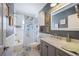 Clean bathroom with a bathtub, shower, and updated vanity with marble top at 17 Loma Verde # 17, Lakeland, FL 33813