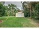 Private backyard with a shed and lush landscaping at 1806 17Th Nw St, Winter Haven, FL 33881