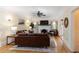 Living room with leather furniture, hardwood floors and fireplace at 1806 17Th Nw St, Winter Haven, FL 33881