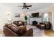 Living room featuring leather sofas, fireplace, and large TV at 1806 17Th Nw St, Winter Haven, FL 33881