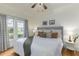 Bright bedroom with hardwood floors, king-size bed, and large windows at 1806 17Th Nw St, Winter Haven, FL 33881
