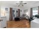 Cozy bedroom with hardwood floors, a window with curtains and a plaid bedspread at 1806 17Th Nw St, Winter Haven, FL 33881