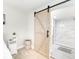 Ensuite bathroom with barn door entry and walk in shower at 2430 Old Homeland Rd, Bartow, FL 33830