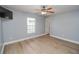 Bright bedroom featuring ceiling fan and wood-look floors at 300 Winona Ct, Auburndale, FL 33823