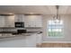 Modern kitchen with white cabinets, black appliances and a breakfast bar at 300 Winona Ct, Auburndale, FL 33823