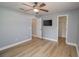 Bright bedroom with ceiling fan, walk-in closet and wood-look floors at 300 Winona Ct, Auburndale, FL 33823