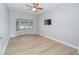 Living room with bay window, hardwood floors, and mounted TV at 300 Winona Ct, Auburndale, FL 33823