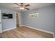 Spacious bedroom with ceiling fan, wood-look floors, and window at 300 Winona Ct, Auburndale, FL 33823