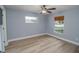 Well-lit bedroom with ceiling fan and wood-look floors at 300 Winona Ct, Auburndale, FL 33823