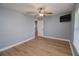 Bedroom with ceiling fan, wood-look floors and large window at 300 Winona Ct, Auburndale, FL 33823