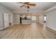 Open living room and kitchen with neutral colors and hardwood floors at 300 Winona Ct, Auburndale, FL 33823