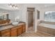 Bathroom with a large vanity, soaking tub, and shower at 300 Winona Ct, Auburndale, FL 33823
