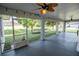 Spacious screened patio with ceiling fan, string lights, and view of backyard at 300 Winona Ct, Auburndale, FL 33823