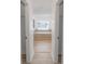 Bathroom with a bathtub, window, and light wood floors at 300 Winona Ct, Auburndale, FL 33823