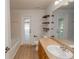 Bathroom with tub, vanity, and door to backyard at 300 Winona Ct, Auburndale, FL 33823