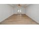 Bright bedroom with wood-look floors, ceiling fan, and access to a patio at 300 Winona Ct, Auburndale, FL 33823