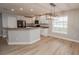 Modern kitchen with white cabinets, black appliances and a breakfast bar at 300 Winona Ct, Auburndale, FL 33823