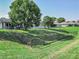 Backyard view of house with fenced in yard and large tree at 300 Winona Ct, Auburndale, FL 33823