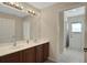 Bathroom with double vanity and shower with access to bedroom at 109 Costa Loop, Auburndale, FL 33823