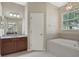 Main bathroom with soaking tub, shower, and a double vanity at 109 Costa Loop, Auburndale, FL 33823