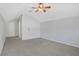Bright bedroom with neutral walls, ceiling fan, and access to hallway at 109 Costa Loop, Auburndale, FL 33823