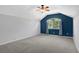 Spacious bedroom with blue accent wall, ceiling fan, and large window at 109 Costa Loop, Auburndale, FL 33823