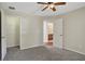 Bedroom with carpet, ceiling fan and access to bathroom at 109 Costa Loop, Auburndale, FL 33823