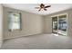 Bright bedroom with carpeting and sliding doors to patio at 109 Costa Loop, Auburndale, FL 33823
