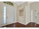 Bright entryway with hardwood floors and built-in shelving at 109 Costa Loop, Auburndale, FL 33823