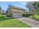 Attached two-car garage with stone accents at 109 Costa Loop, Auburndale, FL 33823