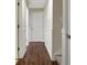 Long hallway with dark hardwood floors and wainscoting at 109 Costa Loop, Auburndale, FL 33823