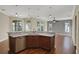 Open kitchen with island, stainless steel appliances, and hardwood floors at 109 Costa Loop, Auburndale, FL 33823