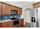 Kitchen with stainless steel appliances and blue tile backsplash at 109 Costa Loop, Auburndale, FL 33823