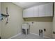 Laundry room with white cabinets and a utility sink at 109 Costa Loop, Auburndale, FL 33823