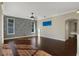 Bright living room with hardwood floors, stone accent wall, and access to backyard at 109 Costa Loop, Auburndale, FL 33823