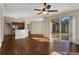 Living room with hardwood floors, sliding doors to pool area, and ceiling fan at 109 Costa Loop, Auburndale, FL 33823