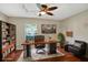 Virtually staged home office with a large desk and bookcase at 109 Costa Loop, Auburndale, FL 33823