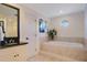 Bathroom featuring a soaking tub, dark countertops, and white cabinetry at 5936 Coveview W Dr, Lakeland, FL 33813