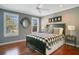 Bedroom with hardwood floors, black bed, and decorative accents at 5936 Coveview W Dr, Lakeland, FL 33813