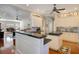 View of the kitchen with white cabinets, dark countertops, and an island at 5936 Coveview W Dr, Lakeland, FL 33813