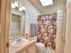 Bathroom with skylight, floral shower curtain, and vanity at 1742 Fox Hill Dr, Lakeland, FL 33810