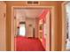 Bedroom with red carpet, white dresser and access to bathroom at 1742 Fox Hill Dr, Lakeland, FL 33810