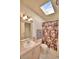 Bathroom with skylight, floral shower curtain, and vanity at 1742 Fox Hill Dr, Lakeland, FL 33810