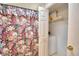 Bathroom with floral shower curtain and adjacent laundry closet at 1742 Fox Hill Dr, Lakeland, FL 33810