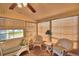 Bright sunroom with wicker furniture and window blinds at 1742 Fox Hill Dr, Lakeland, FL 33810